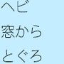 蛇がとぐろを巻いているコンクリート床の倉庫の隅